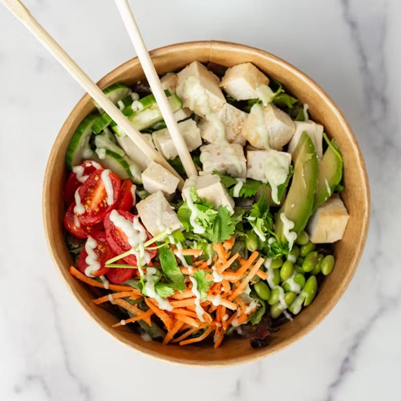 Up Leaf Café's Asian tofu salad with avocado, tomatoes, edamame, carrots, and chopsticks.