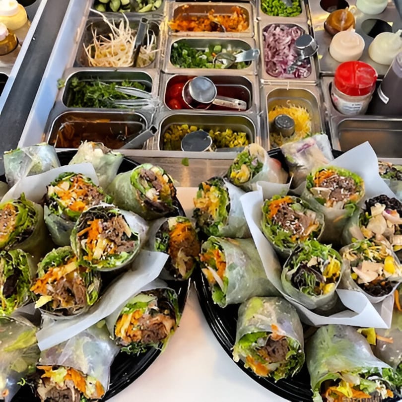 Up Leaf Café's fresh spring rolls with various fillings, alongside a salad bar with ingredients.